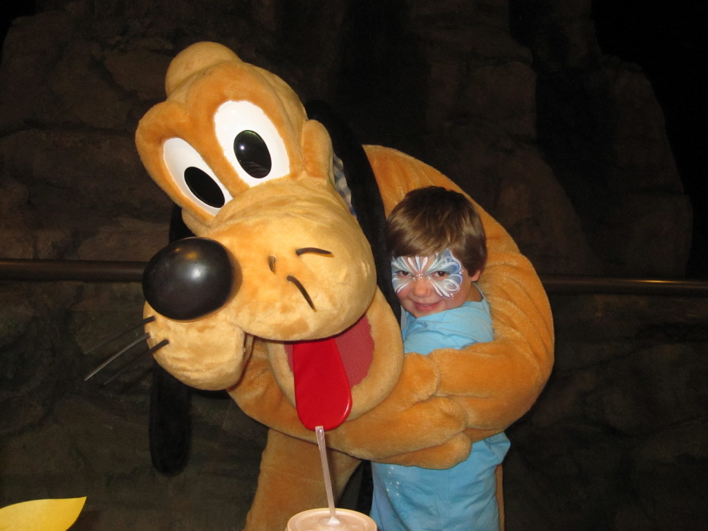 Pluto, Mickey's sidekick, with Emily at the Garden Grill in Epcot! 